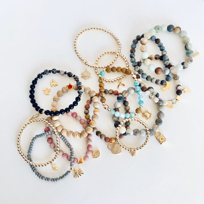 Our CHARMED COLLECTION dresses up our bracelets with the highest quality Gold Filled and Gold Plated charms